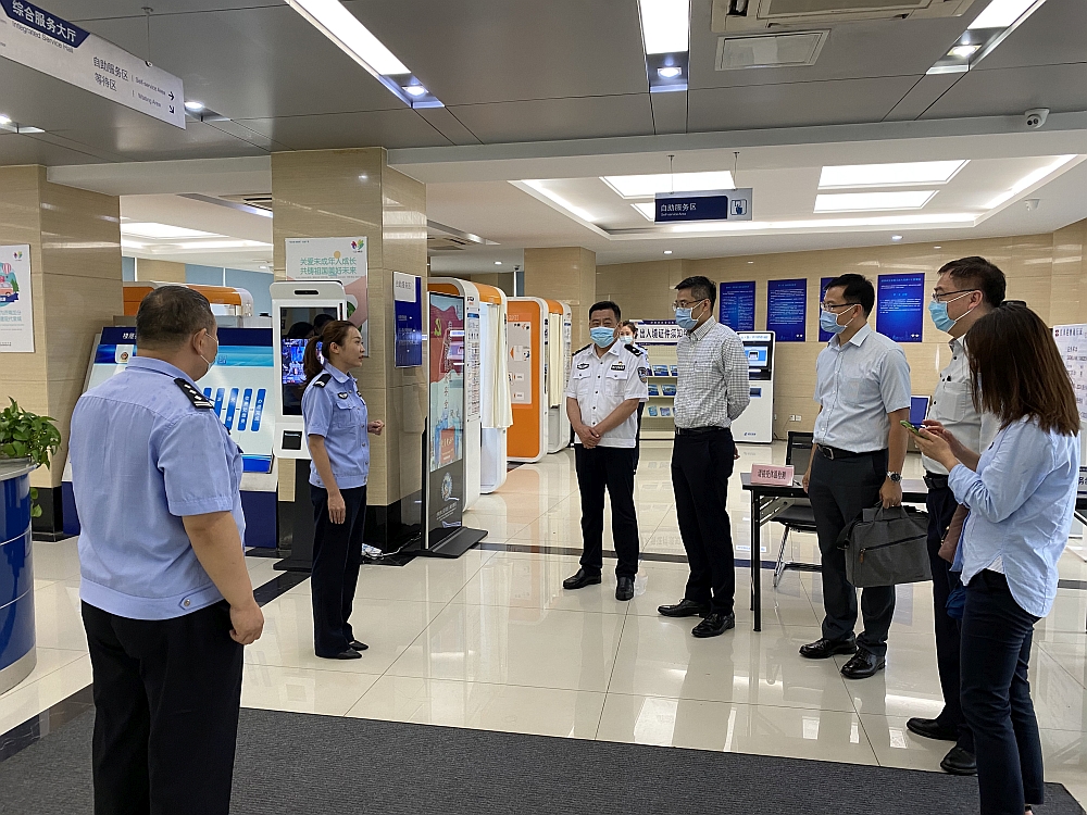 駐滬辦副主任翁榮楨（右四）在濟南市公安局出入境管理局局長張恒棟（左三）陪同下參觀當地出入境辦證大廳